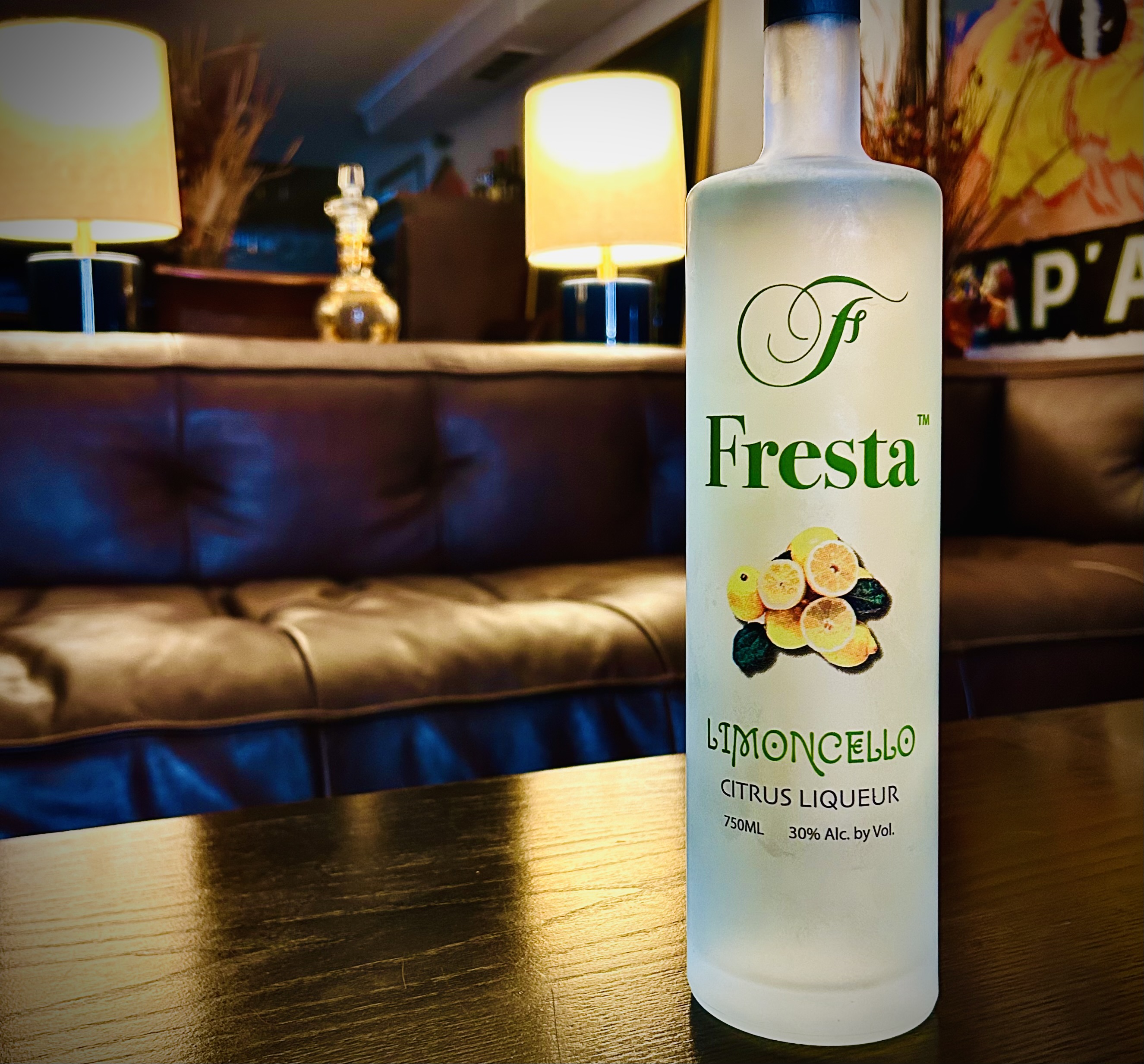 Fresta-Limoncello-bottle-on-table-with-couch-in-background.jpeg